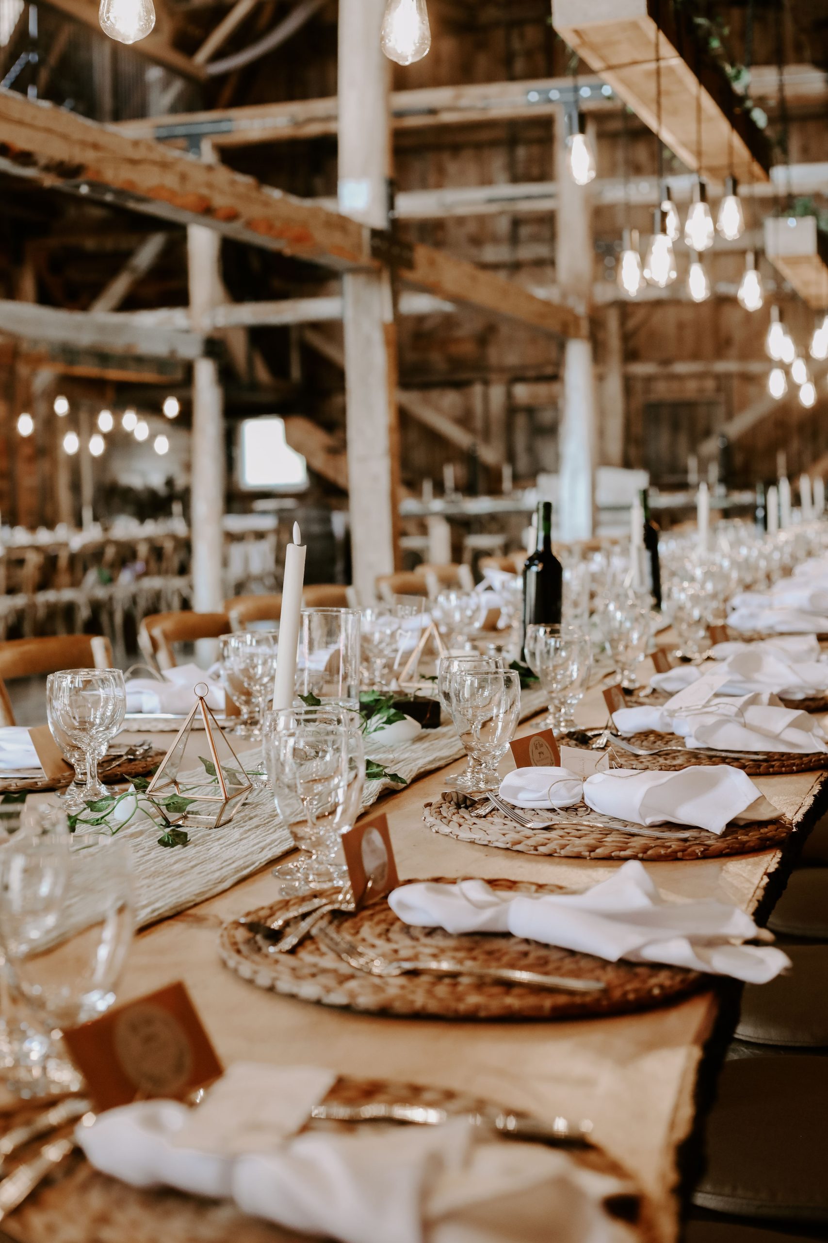 Harvest table set with placemats, napkins, and candles
